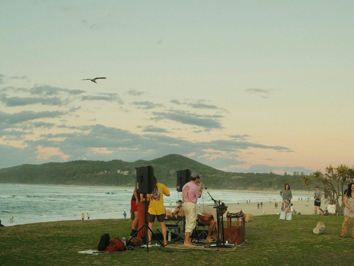 a group of people playing instruments on a beach