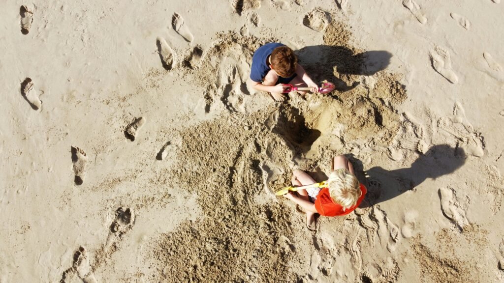 two-kids-playing-in-the-sand